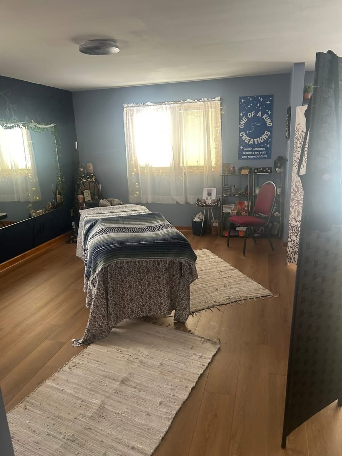 Calm massage treatment room with soft lighting and warm textiles